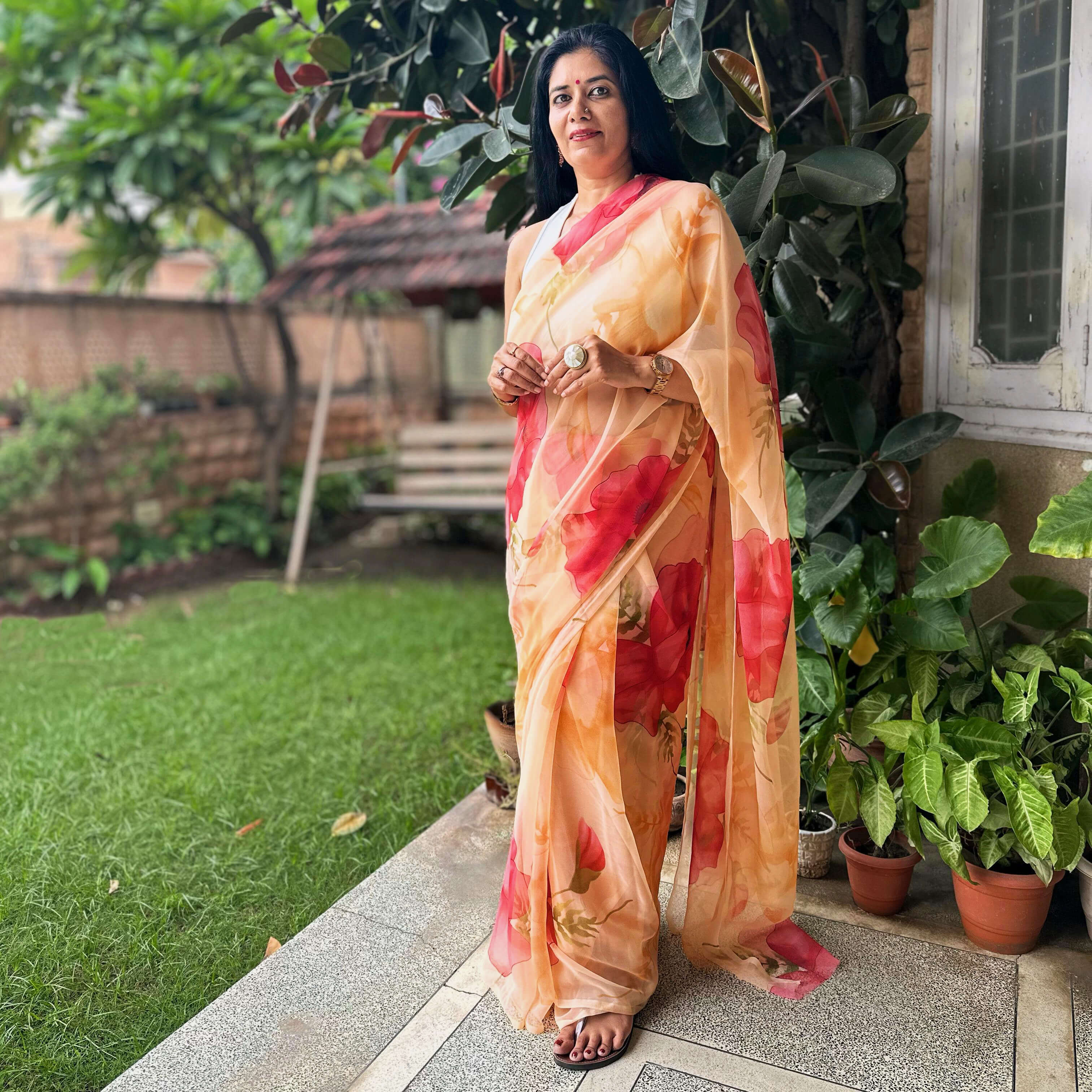High quality designer premium chiffon saree handmade using natural dye and matching blouse in floral print in peach orange colour online shopping india