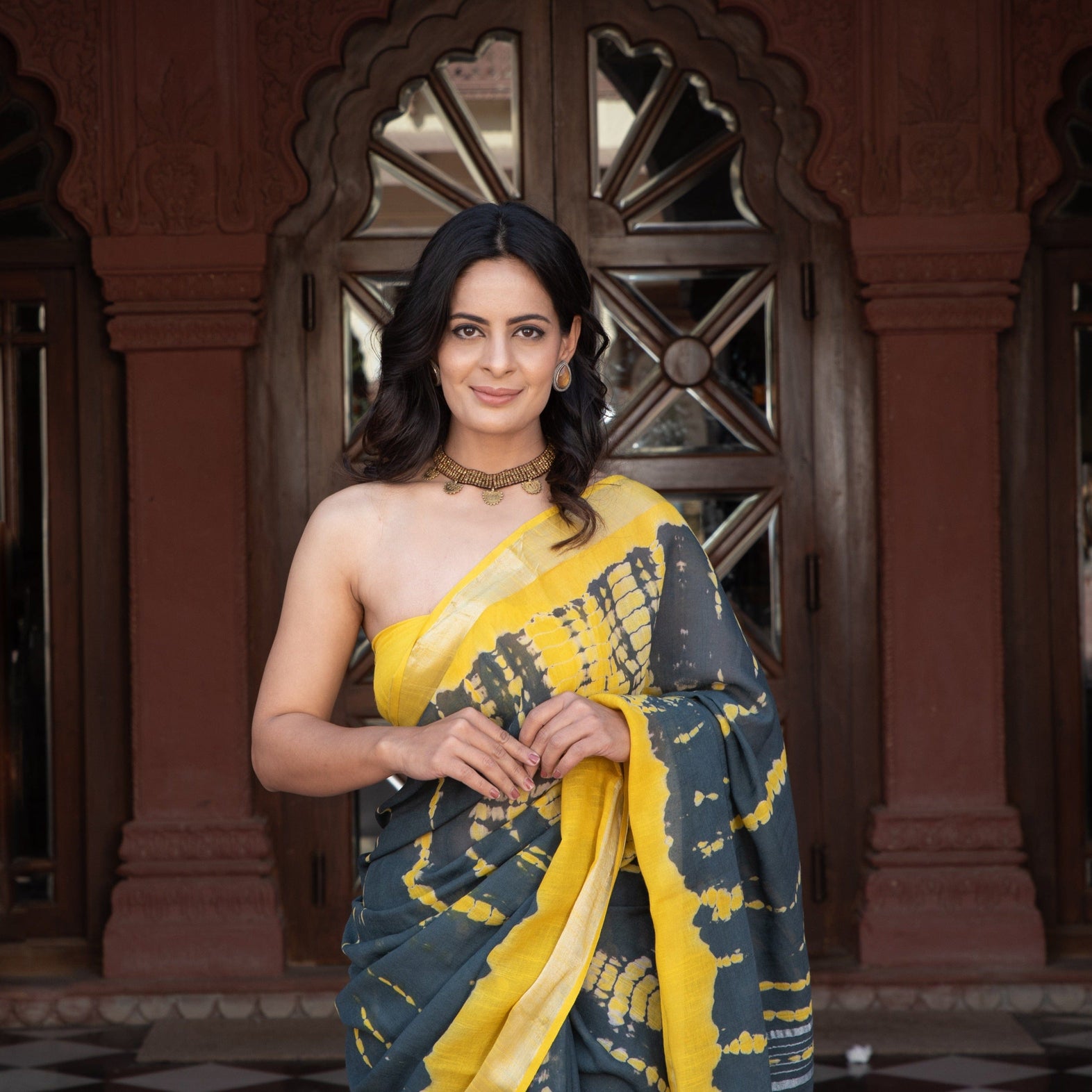Sustainable fashion shibori linen saree and blouse using organic dye in yellow and black for online shopping made in India